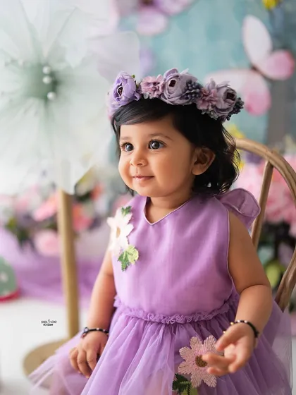 A beautiful close-up portrait of this little girl, with a lovely floral crown that perfectly matches the enchanted garden theme.