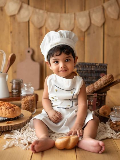 Such a charming smile from this little chef. The rustic wooden backdrop in my studio was perfect for this baking theme.