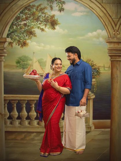 Set against a painted backdrop of a serene waterfront, this couple's portrait is rich with traditional symbolism, including the offering of fruits, representing prosperity and new beginnings.