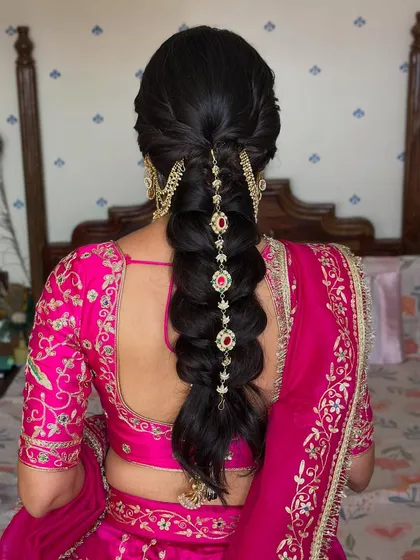 A stunning view of the intricate braid, adorned with beautiful hair jewelry. This hairstyle is a perfect blend of tradition and modern bridal trends.