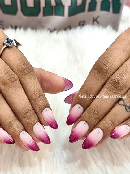 Another view of the stunning pink and magenta ombré nails, showing off the sharp almond shape and the flawless color blend.