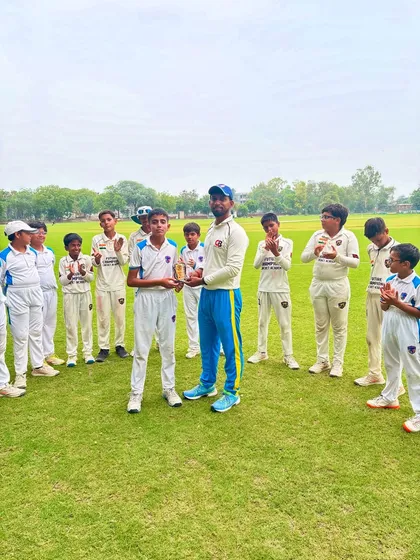 Apurv Tyagi receiving his Player of the Match award, surrounded by his proud teammates.
