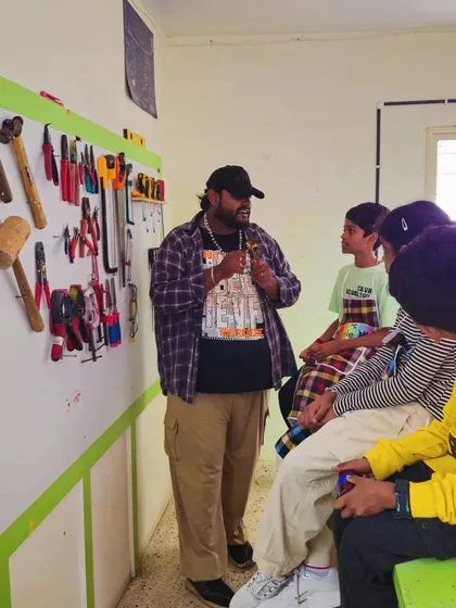 Our workshop is a real lab filled with real tools. An instructor explains the function of different woodworking and engineering tools, ensuring students understand their purpose and safety before starting a project.