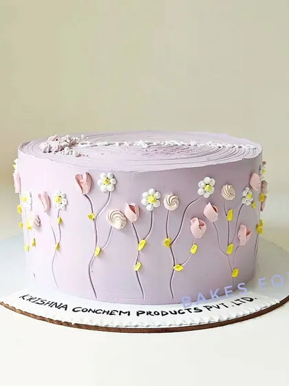 A lovely lavender cake with tiny, intricate buttercream flowers piped around the side. This design showcases my detailed piping work and is perfect for a sophisticated celebration.
