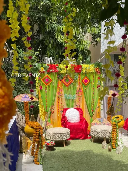 Another angle of the garden Mehendi setup, showing how the hanging floral strings and side props create a complete, immersive festive environment.