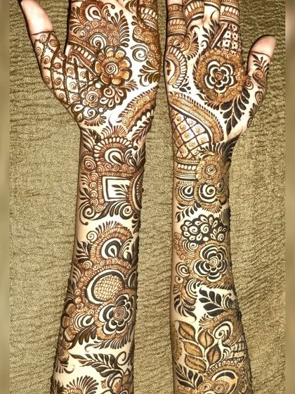 A full-arm Indo-Arabic design that is packed with detail. From the wrists to the fingertips, every space is filled with beautiful patterns like paisleys, florals, and geometric shapes.