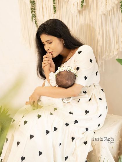A mother's gentle kiss for her newborn. These are the quiet, tender moments I love to capture, showing the deep and instant connection between a mother and her child.