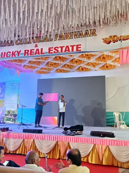 This is a practical stage setup for a public or community event. It includes a branded backdrop for sponsors, a large LED screen for visuals, and basic stage skirting, ensuring a functional and professional look.