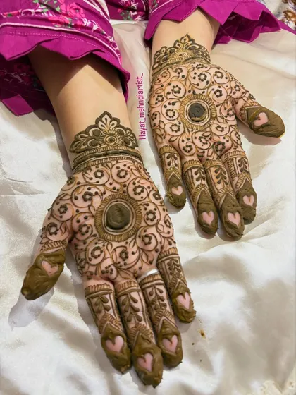 Who says you can't have a little fun with your mehndi? I love adding cute details like these little hearts on the fingertips to a traditional mandala design. It's a modern twist on a classic look.