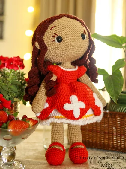 Lily the Doll, captured in the warm glow of indoor lights. Her presence adds a touch of handmade warmth to any corner of the home.