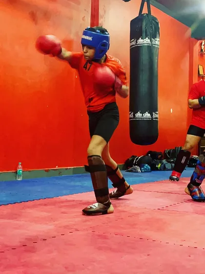 A young athlete practices his jab cross combination on a heavy bag. Bag work is essential for developing power, stamina, and proper punching technique in our boxing classes for kids.