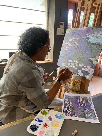 This student is focused on capturing the reflections in the water, a key element of Monet's impressionist style.