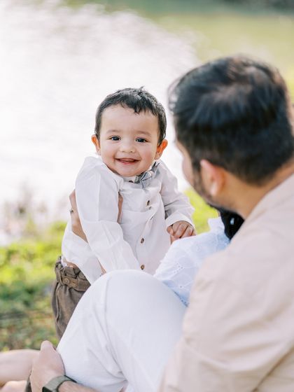 A happy baby boy enjoying the sunshine during his outdoor pre-birthday shoot. The natural light and setting are perfect.