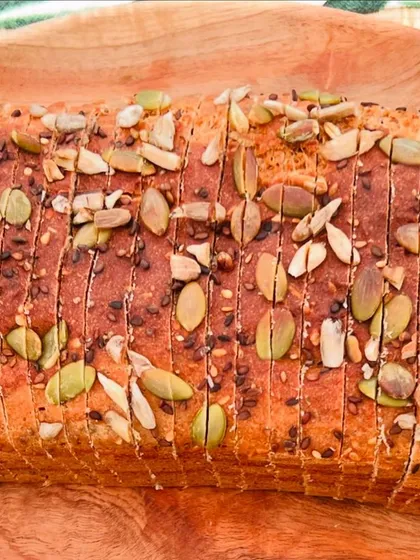 A close look at my signature flourless lentil bread. It's topped with a healthy mix of pumpkin, sunflower, chia, and sesame seeds for extra nutrition and crunch. This is a gluten-free bread you can enjoy without worry.