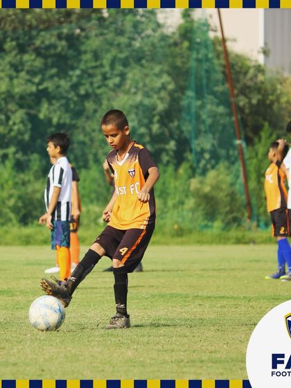 A young player practices ball control, demonstrating the focus we instill in our grassroots program.
