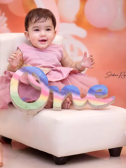 Posing like a pro for her first birthday. These milestone sessions are designed to be fun and comfortable, whether at my home studio or during a home visit.