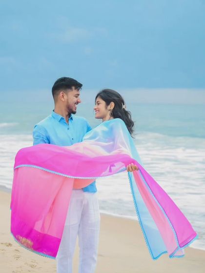 The beach provides a perfect canvas for romantic and playful couple portraits. This destination shoot captures a classic lift against the backdrop of the waves and open sky.