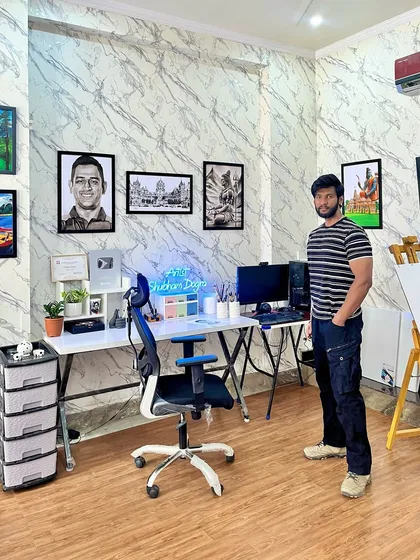 My personal workspace within the studio, where I create my own pieces. The walls are decorated with my art, from portraits to landscapes, to serve as inspiration.