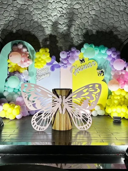 We brought a magical butterfly garden to life for a first birthday party. This whimsical setup features a pastel balloon arch, custom butterfly cutouts, and soft lighting to create an enchanting atmosphere for the little one's big day.