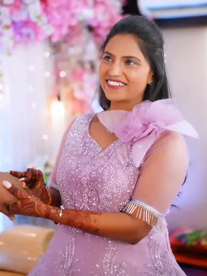 A close-up of the bride's happy expression as she gets her ring, her makeup looking soft and pretty.