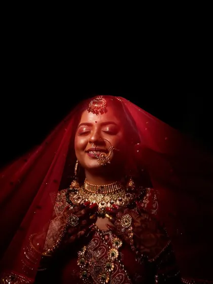 The moment a bride is lost in her own thoughts, just before the ceremony begins. I used dramatic lighting to highlight the rich red of her veil and the intricate details of her bridal jewellery, creating a timeless and soulful portrait.