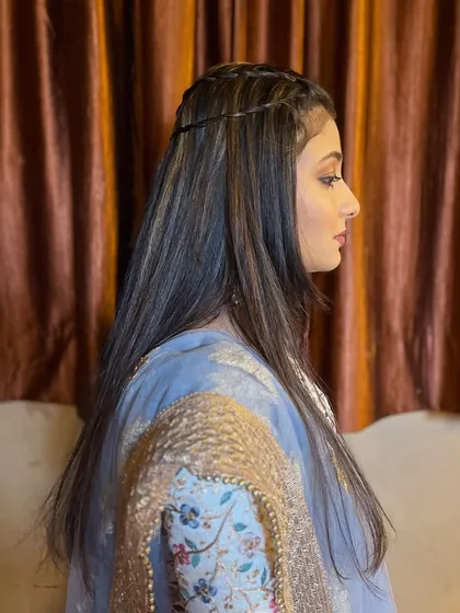 A simple and chic hairstyle with two thin braids pulling the hair back, keeping it neat and stylish.