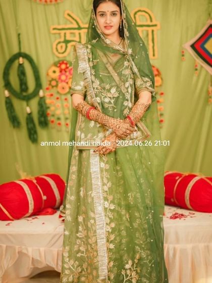 A classic, elegant pose of the bride at her mehendi ceremony, looking regal and ready for her big day.