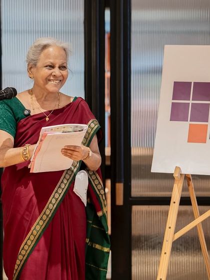 An elder member of our community graces the stage with her wisdom and poetry, truly embodying the spirit of breaking boundaries at any age.