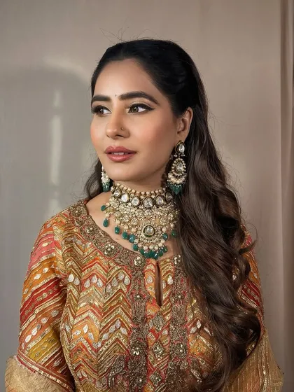 A side profile, showing the beautiful waves in her hair and the flawless makeup.