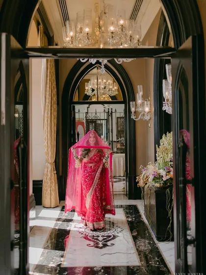 A moment of anticipation. I styled this shot to capture the bride's entrance through the grand, sunlit corridors of the Taj Mahal Mumbai, her vibrant Sabyasachi saree creating a stunning focal point against the classic architecture.
