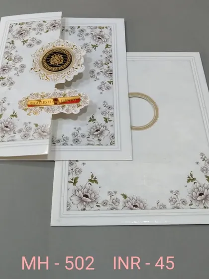 A clean white invitation with a floral print and unique gate-fold closure. The design is modern and interactive, with gold emblems for a touch of luxury.