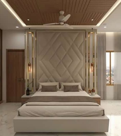 This is a 3D concept for a grand master bedroom. The design includes a full-wall cushioned headboard with metal inlays, a veneer false ceiling, and a large wardrobe with frosted glass shutters.