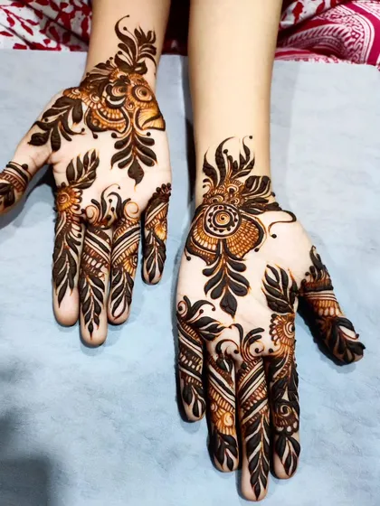 This design focuses on bold, dark leaves and delicate floral buds, creating a striking contrast.