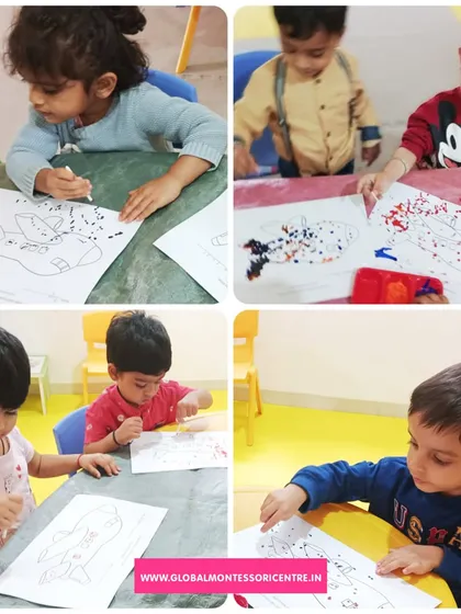 Children use their fingers and sponges to create colorful art, a hands-on activity that is both fun and beneficial for their sensory development.