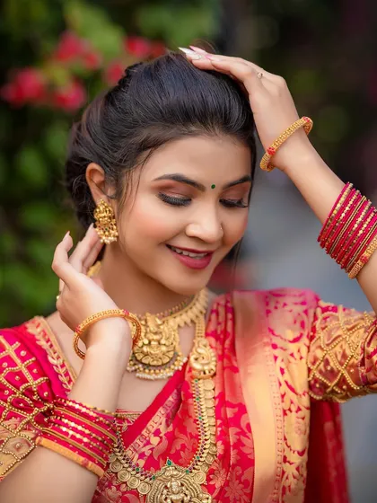 A close-up of a model styled for a South Indian bridal look, her expression soft and serene.