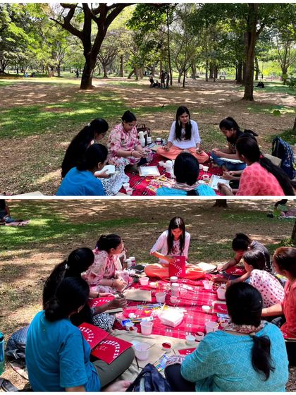 A wide and close-up view of me leading an art session in the park. The atmosphere is relaxed and informal, encouraging conversation and learning in a beautiful outdoor setting.