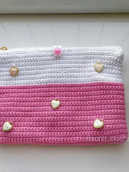 For the pink lover, a custom-made crochet clutch. This one is half white and half pink, and I added these adorable little heart charms to make it extra special.