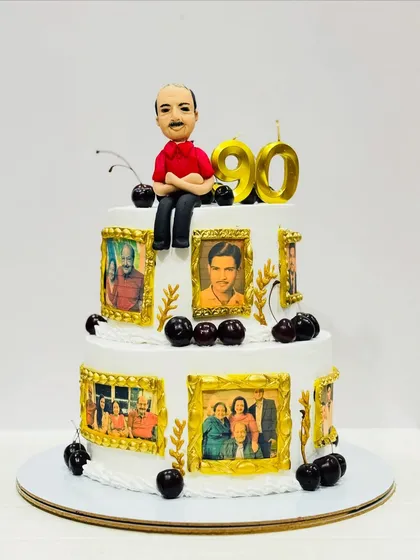 A memory-lane cake for a 90th birthday. This two-tier cake is decorated with edible photo frames showing pictures from the person's life, topped with a custom caricature.