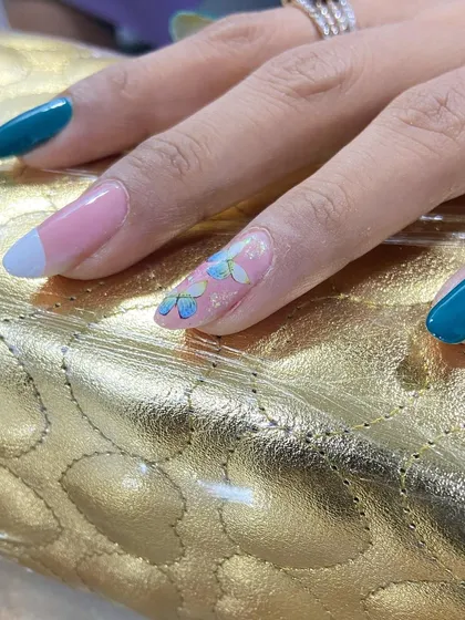 A flawless and unique design. This set features a beautiful teal polish, a modern French tip, and a stunning accent nail with hand-painted butterflies.