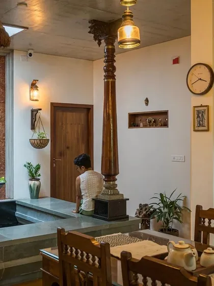 The intricate details of the reclaimed wooden pillars and traditional furniture add a layer of history and craftsmanship to the home.