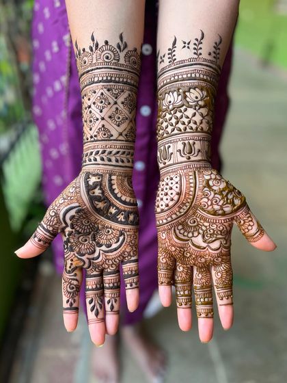 A lovely mid-arm design with a mix of floral and geometric elements, perfect for any celebration.