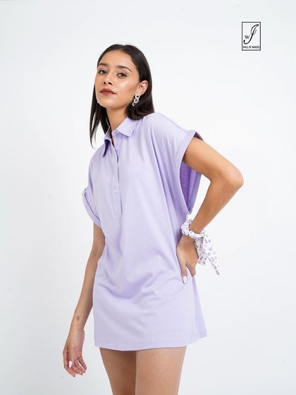 A model in a lavender polo dress, showcasing a sporty yet chic look for a casual wear brand.