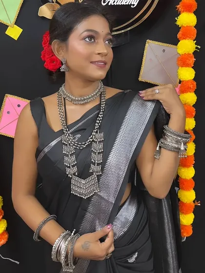 A beautiful portrait showing the full effect of the oxidized jewelry against the black saree.
