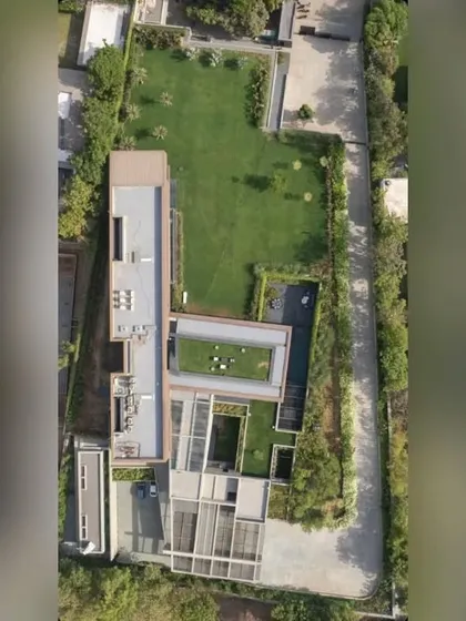 An aerial masterplan view of the Copper House project in Ahmedabad. This shows the overall landscape strategy, including multiple lawns, rooftop gardens, and perimeter planting.