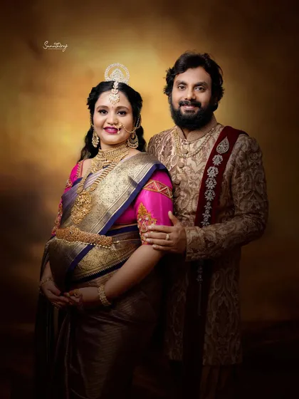 A regal portrait of a couple in traditional attire. The rich fabrics, ornate jewelry, and classic studio lighting create a majestic and timeless image celebrating their heritage.
