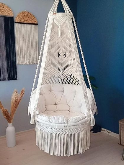 A classic all-white single seater swing. The clean design and matching white cushion make it a versatile piece for any room with a modern or boho aesthetic.