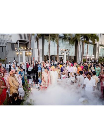 A wide shot of the grand entrance at the 50th-anniversary celebration, with smoke effects creating a magical atmosphere.