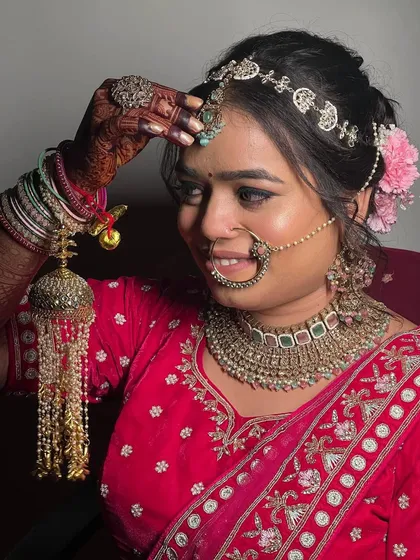 A close-up of this beautiful bride, showing her intricate jewelry and the details of her makeup. The look features a soft smokey eye and a perfectly placed bindi.