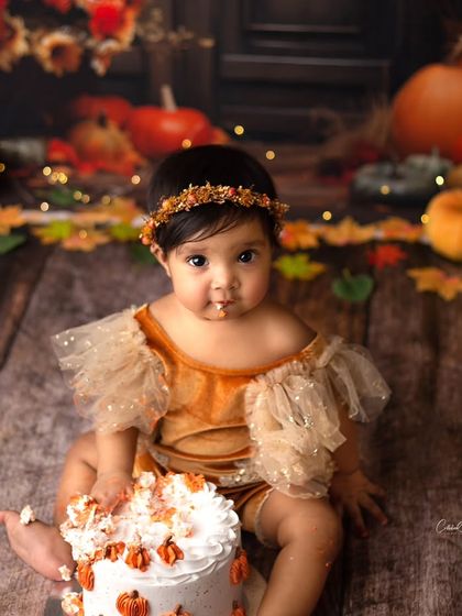 A little taste of the birthday cake. This beautiful princess was so curious during her fall and pumpkin cake smash session.