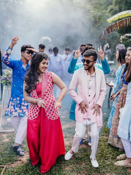 The couple and their friends dancing with smoke effects, capturing the high energy of the party.